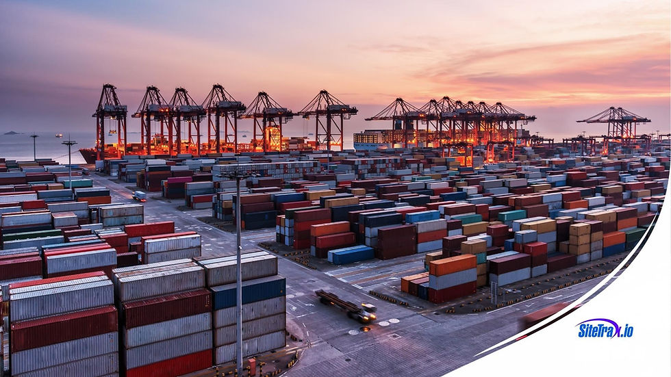Container terminal at sunset: rows of stacked containers, a line of ship-to-shore cranes, and a truck crossing the yard.