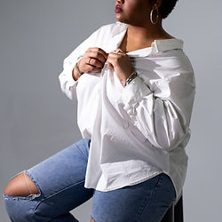 Woman in white shirt and ripped jeans for photography booking