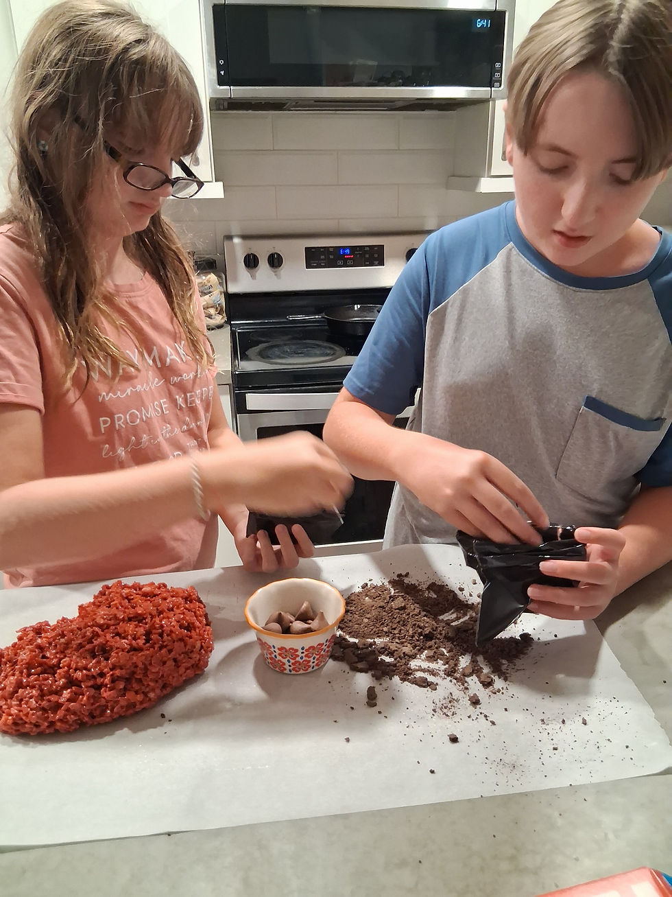 Boy and girl adding ingredients to treat bags