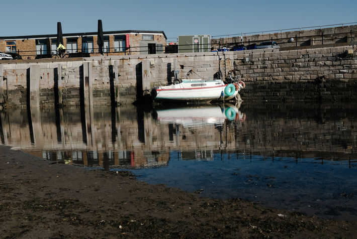 Boat reflection at low tide at Margate Harbour.