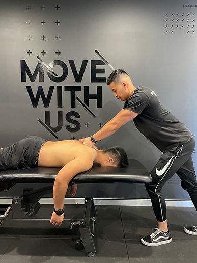 Physiotherapist Jonno massaging a patient's back on a treatment table