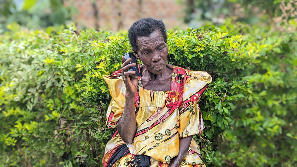 Church leader from Mirembe church listening to Audio bible in Ndeese Village. (1).jpg