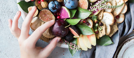 fingers taking food from a bowl