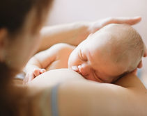 Woman breastfeeding newborn baby