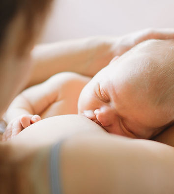 Mother breastfeeding newborn