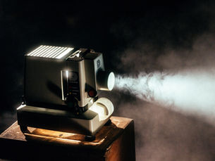 Moving-head stage light projecting a beam through haze