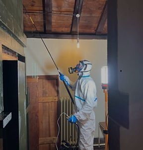 PGM pest technician in full PPE applying