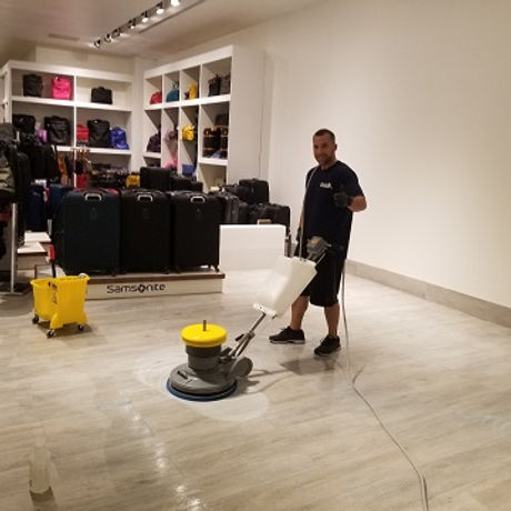 ashley cleaning technician rotary buffing a floor to a high polished finish in retail shop