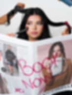 Hair and makeup styling scene with magazine showing ‘Book Now’ message.