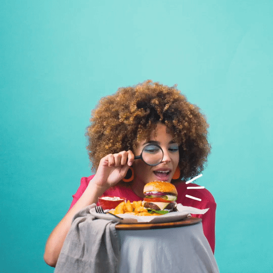 Gif of a woman looking an hamburguer with a magnifying glass