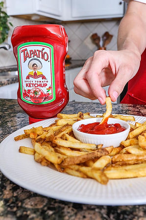 Tempting Tapatio Ketchup accompanies a bowl of crispy french fries, a delightful taste combination