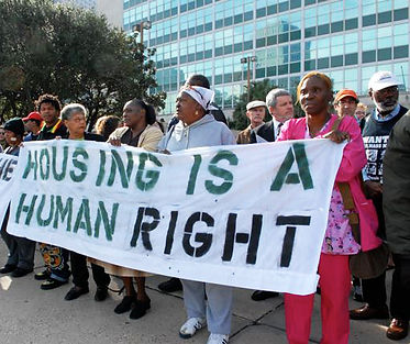 Housing-is-a-human-right-banner-held-by-Black-women.jpg