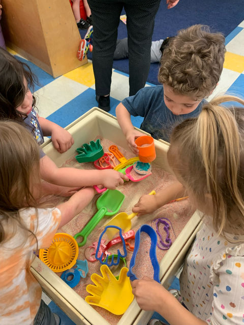 Toddlers playing in a sandbox