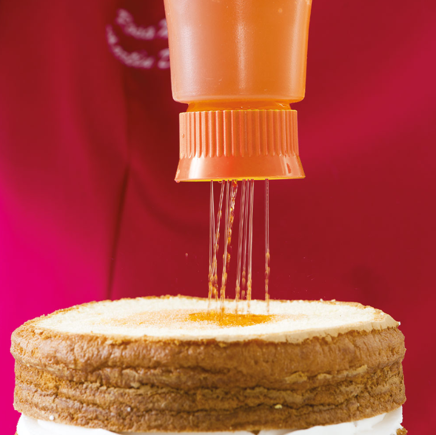 Drizzling icing onto cake layers