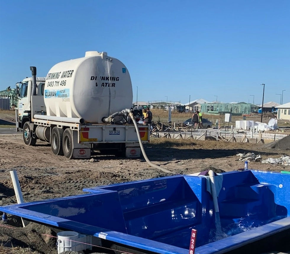 Water delivery truck filling swimming pool with drinking water Sunshine Coast