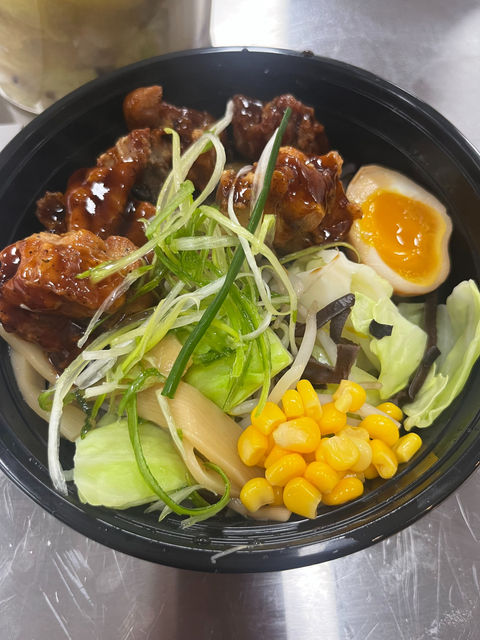 Savory chicken bowl with egg, corn, and greens