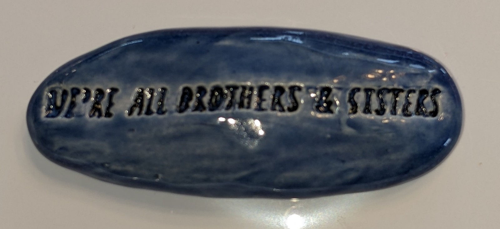 WE'RE ALL BROTHERS & SISTERS Pocket Stone - Sapphire Blue