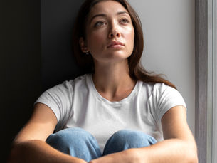 Woman contemplating her thoughts about PMOS.