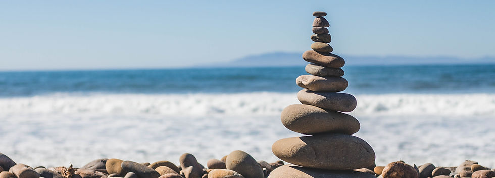 Stacked stones by ocean