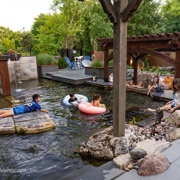 Ecosystem recreation swim and koi pond complete with wetland filtration constructed by Aquascape, Inc.