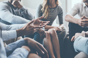 Close-up on discussion. Close-up of people communicating while sitting in circle and gestu