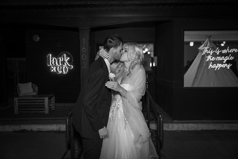 As the couple leave the wedding venue in Utah, USA they share a kiss.
