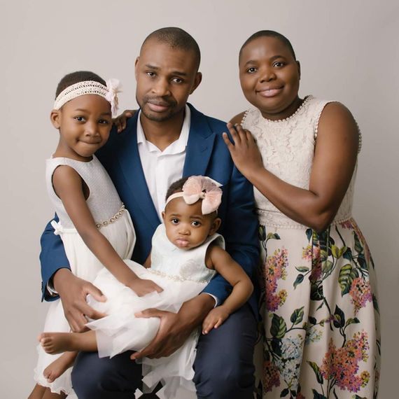 Family portrait: parents and two daughters in Bristol family photo studio