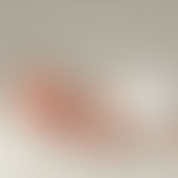 A sleeping newborn baby on a white plain blanket
