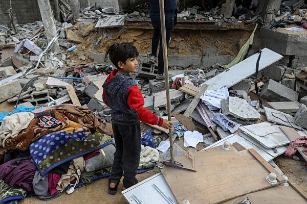 A Palestinian child inspects a destroyed house belonging to the Sheikh Al-Eid family, afte