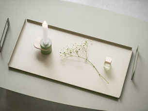 Calm tray with candle and flowers representing gentle Neurodivergent Holiday Boundaries.