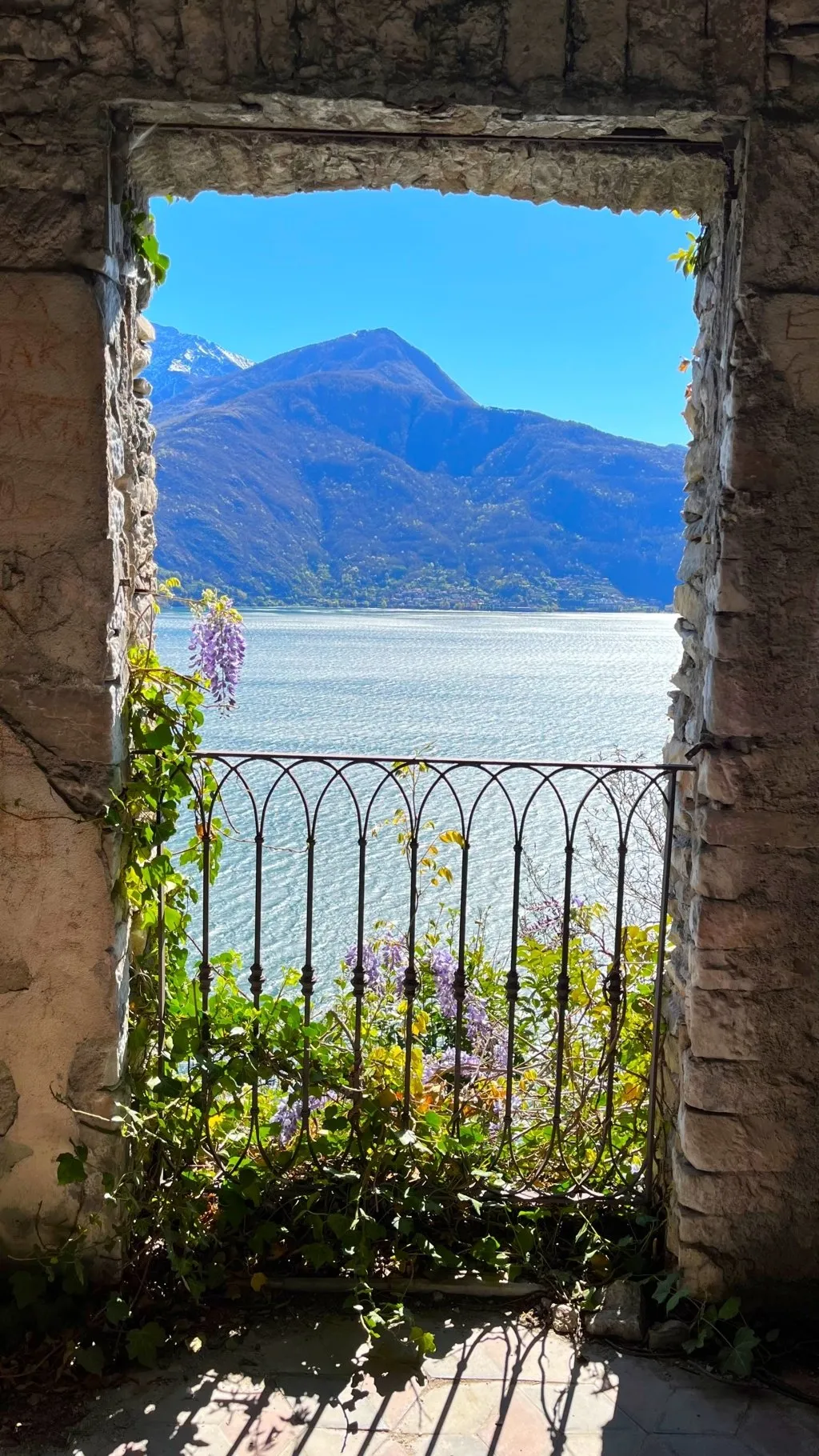 scorcio da finestra in mezzo ai boschi con vista su lago di como