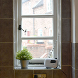 Kitchen window with view of traditional courtyard outside.
