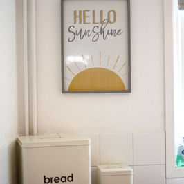 Kitchen counter with decorative bread and biscuits tins.