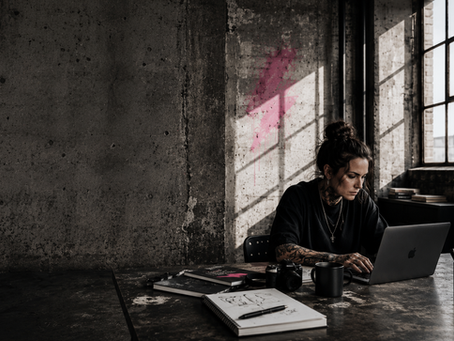 Woman working at her laptop in an industrial space