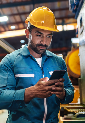 Maintenance worker using a tablet on the plant floor