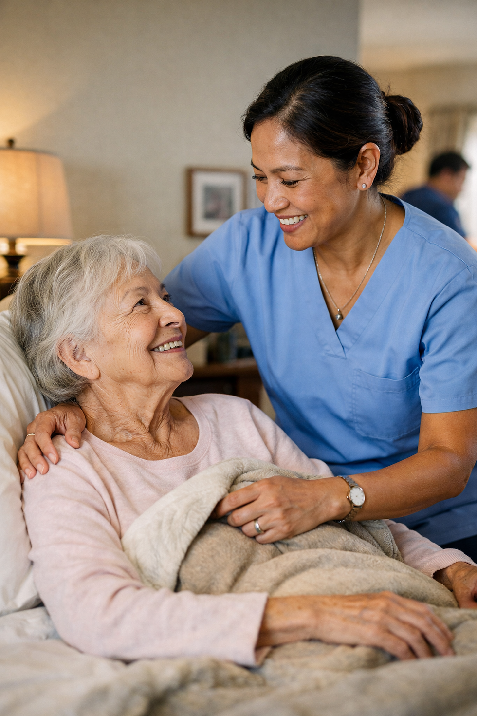 Ultra-realistic photo of a Filipino caregiver in blue scrubs warmly caring for an elderly woman sitting up in bed, gently adjusting her blanket in a cozy home bedroom setting.