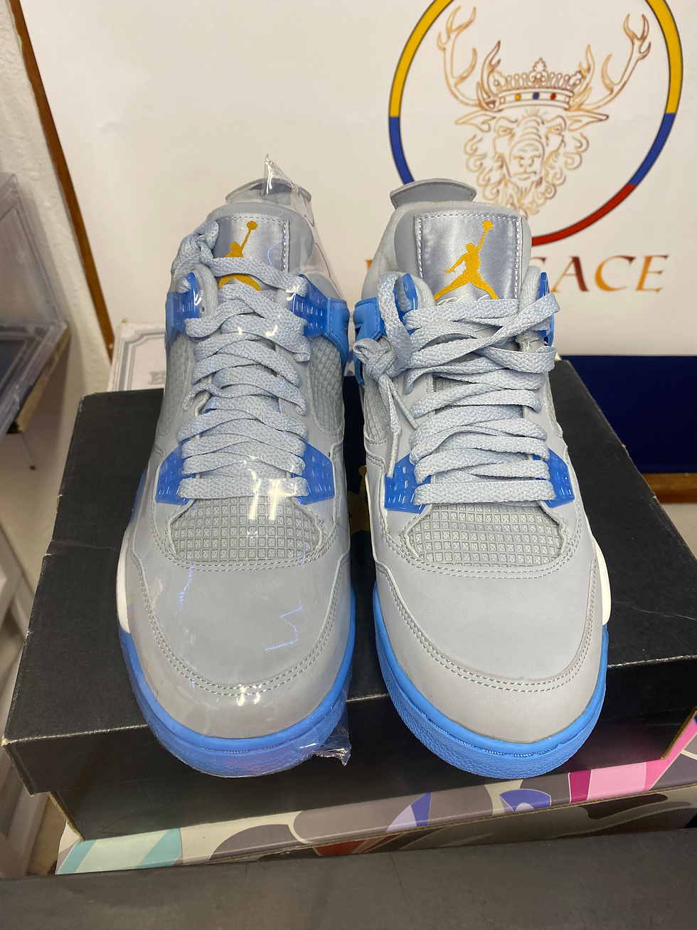 New Nike Air Jordan 4 Retro grey and blue sneakers, yellow logo.