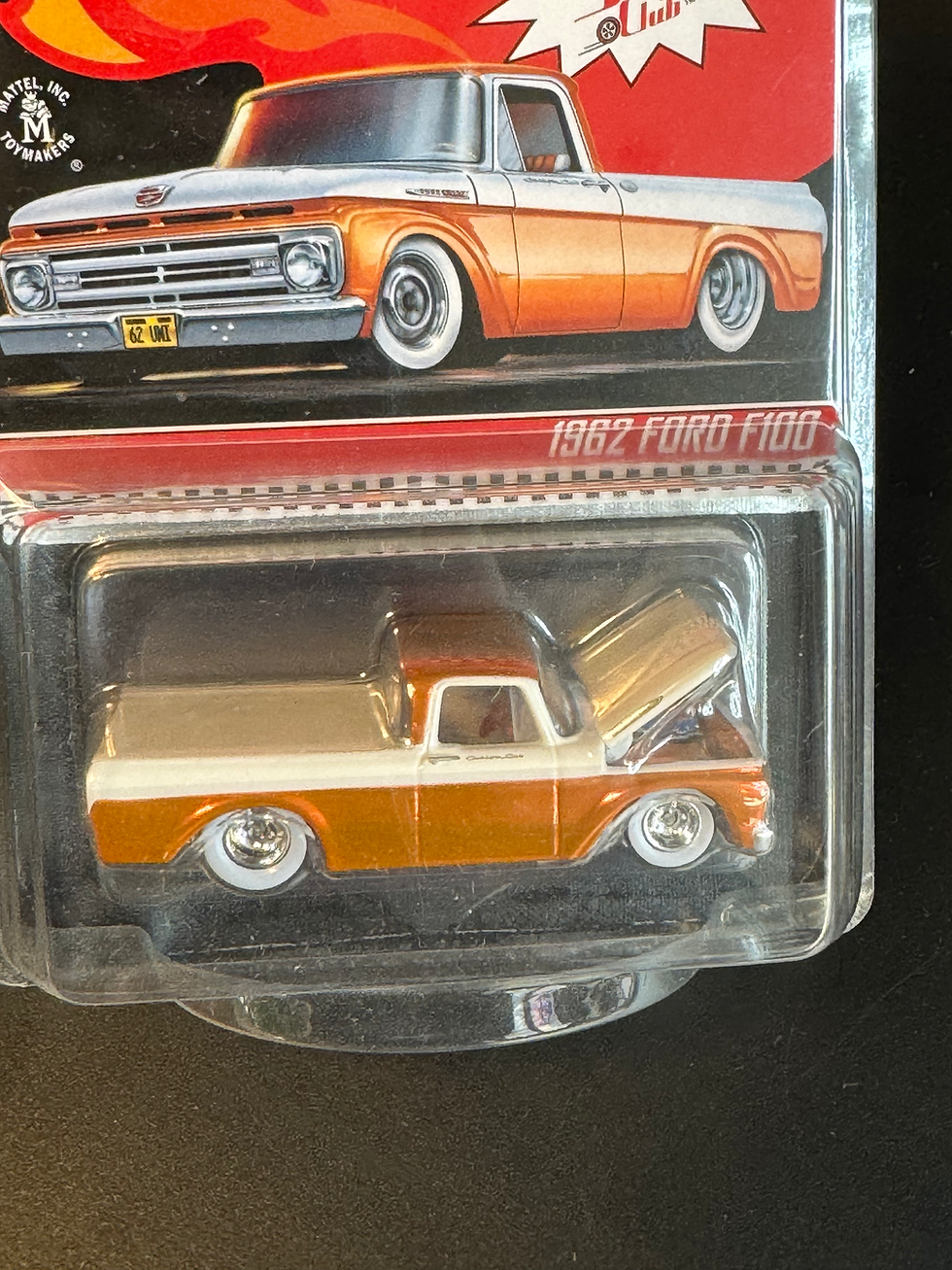 Thumbnail: Orange and white Hot Wheels REDLINE 1962 FORD F100 toy truck, hood open.