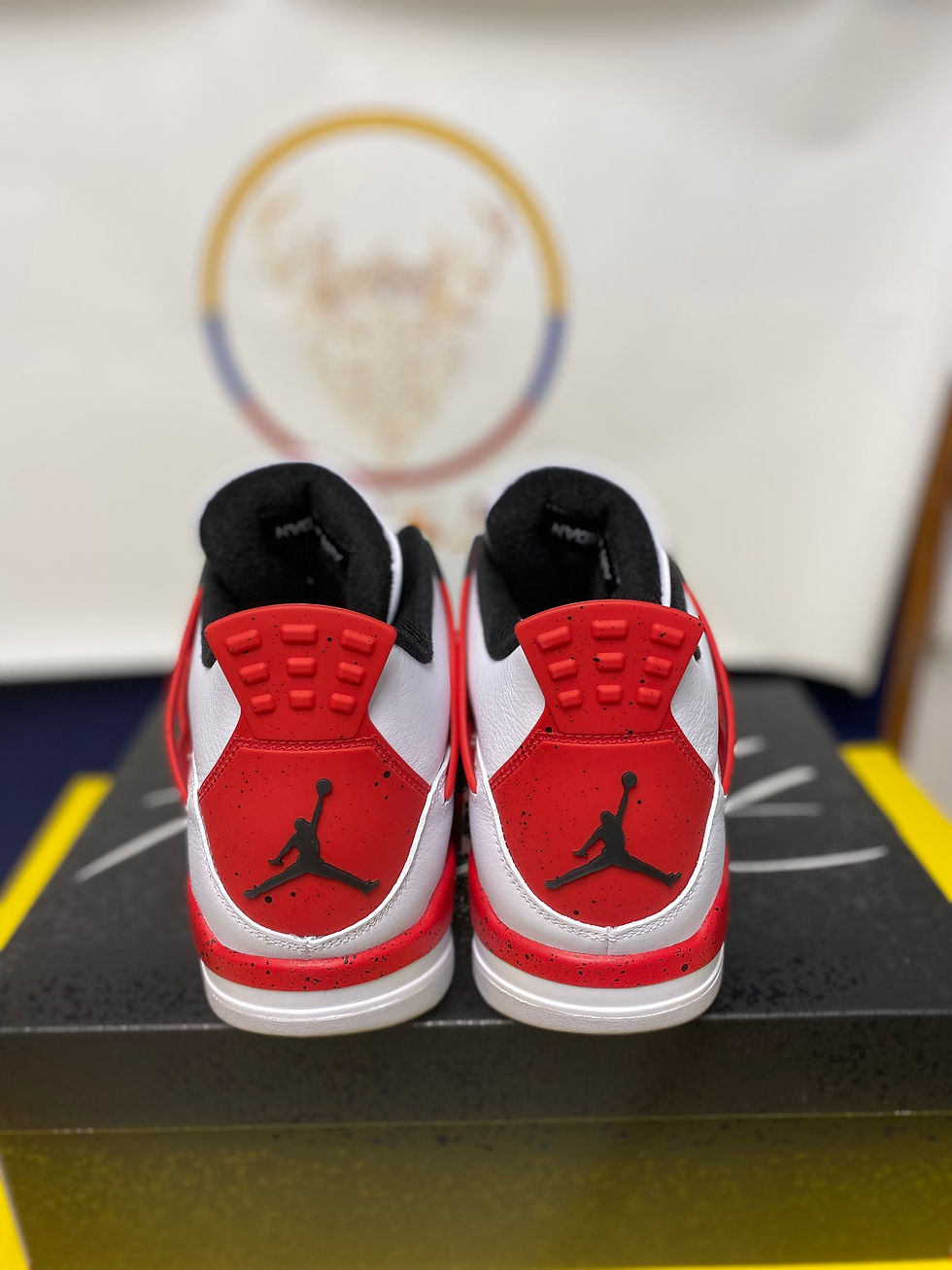 Thumbnail: Pair of red and white Jordan sneakers, showing Jumpman logo on heels.