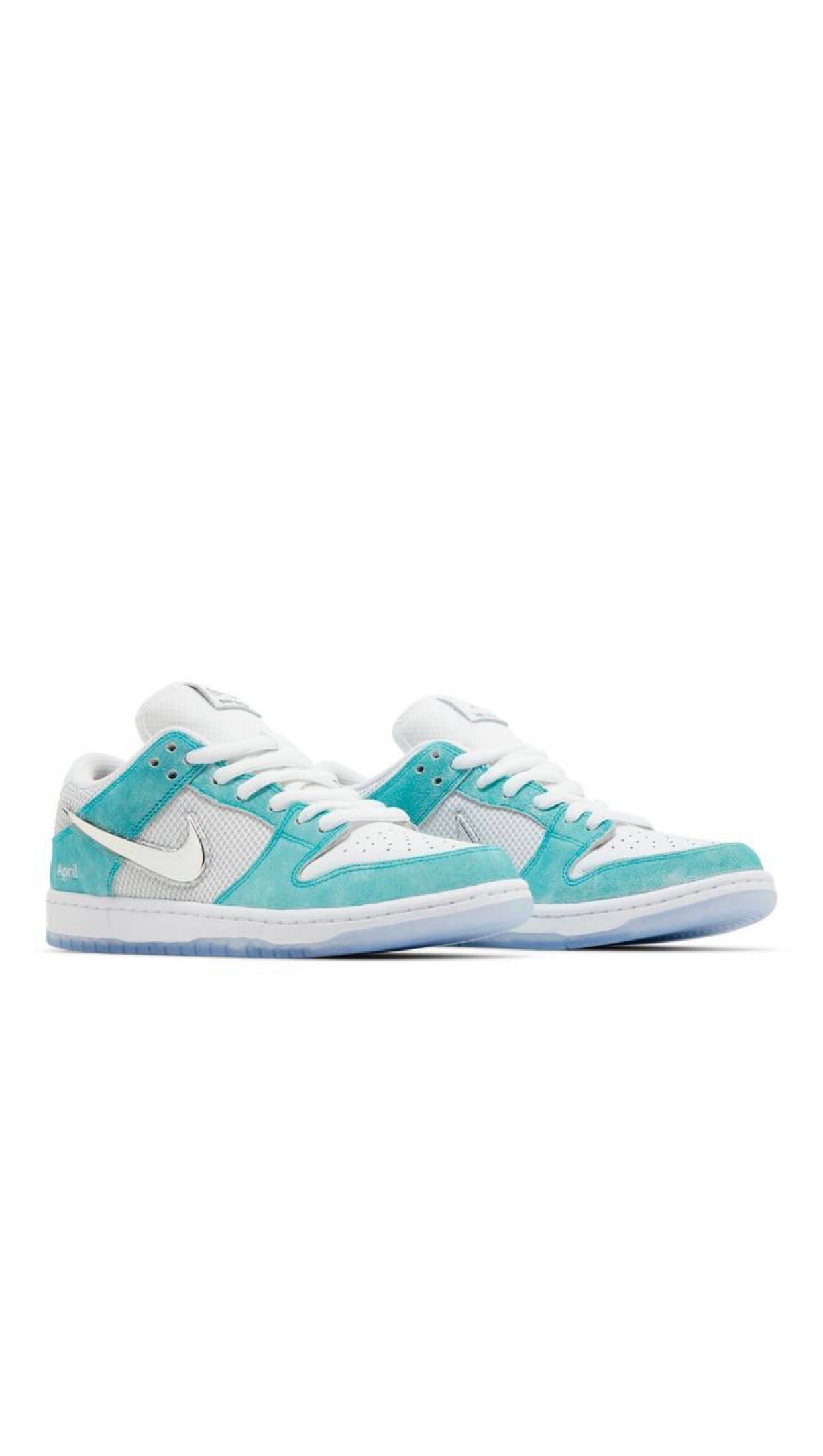 Light blue and white Nike Dunk Low sneakers with suede overlays.