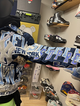 Blue jacket with New York Yankees logo and NEW YORK, SUPREME text.