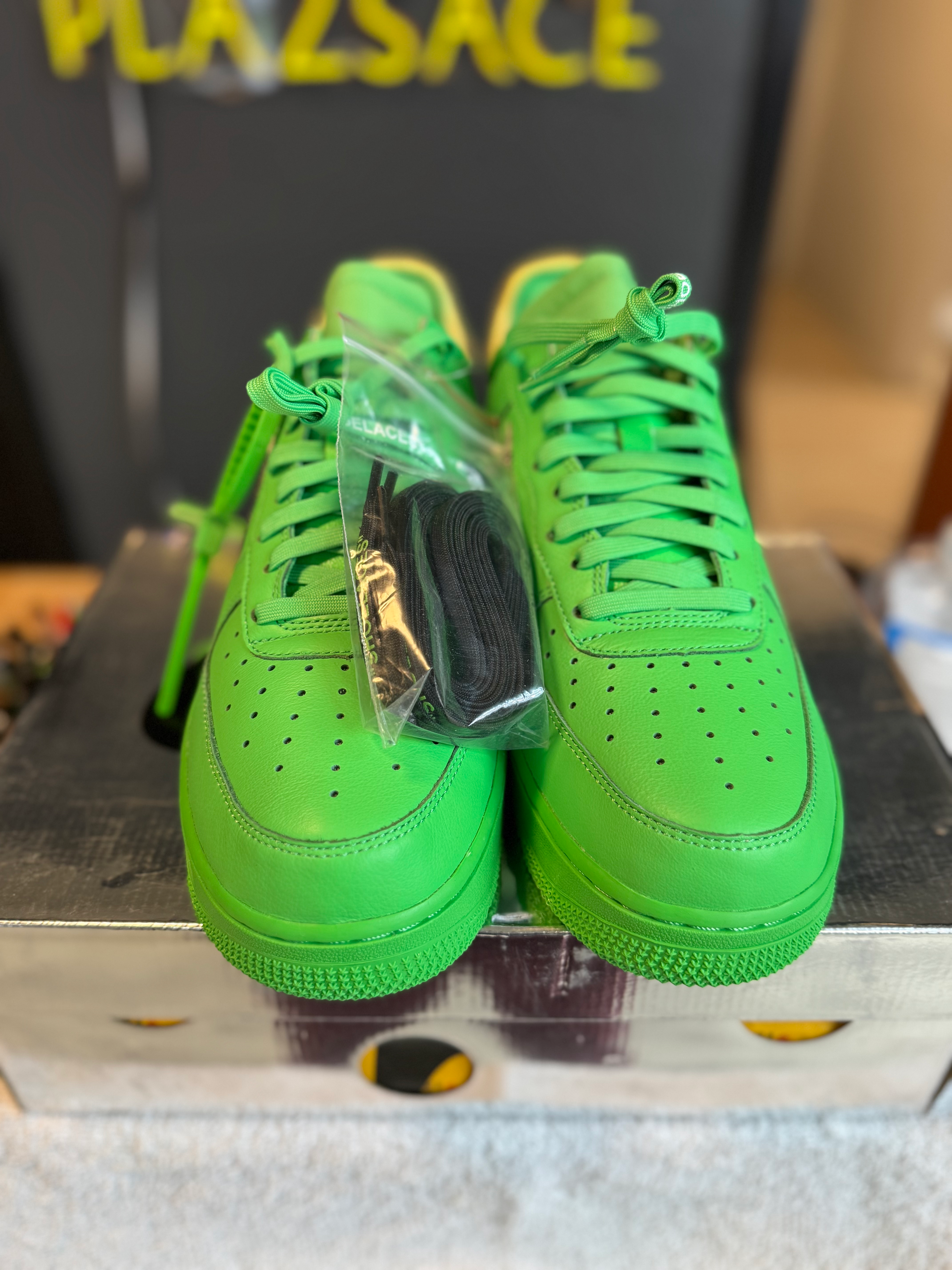 Vibrant green Nike Air Force 1 shoes with black laces.