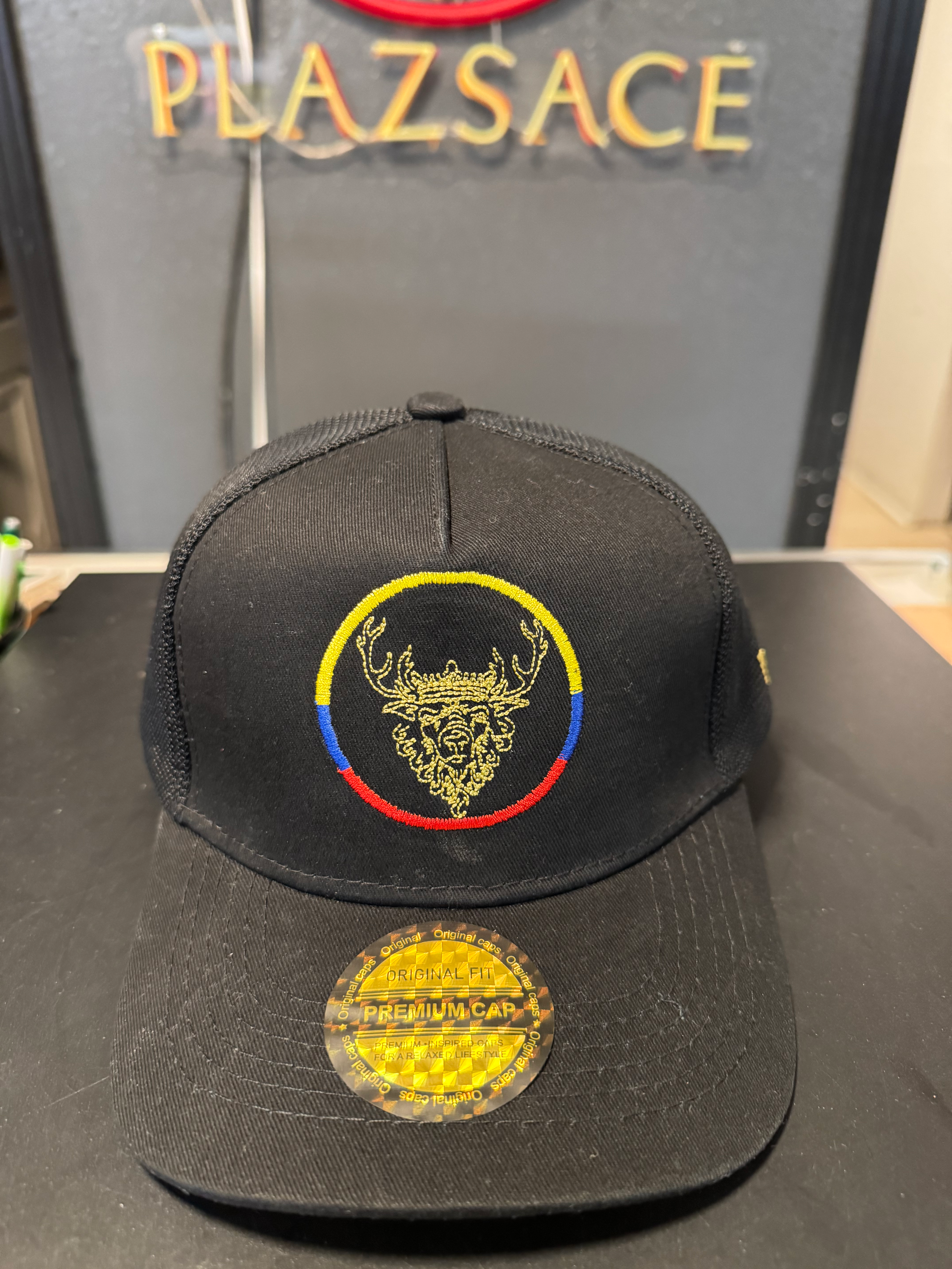 Black baseball cap with embroidered deer head, colorful circle, and 'STILL DREDD' sticker.