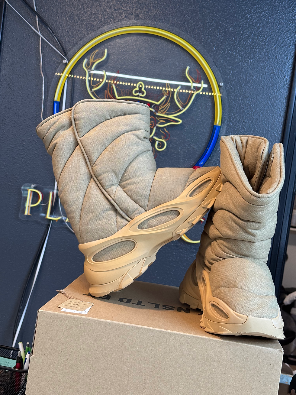 Pair of beige quilted ADIDAS YEEZY NSLTD boots on box.