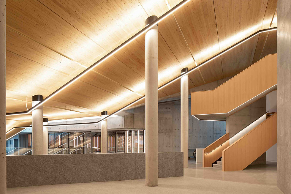 large interior room, with concrete columns and wooden stairs