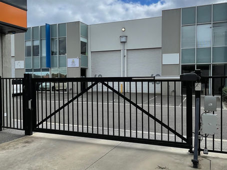 Swing gate opener powering a large commercial swing gate