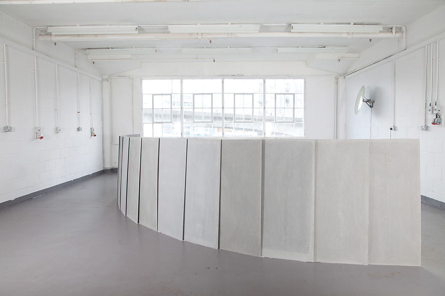 Simona Brinkmann, Ungrammatical Anatomies II, grey Marmox insulation board, cement, fibreglass, steel, graphite. Barrier sculpture, installation, curve obstruction, crowd barrier, post-minimalism, contemporary art.