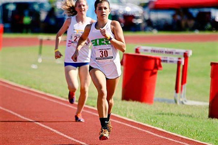 High school runner winning a race on the Owasso Track