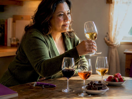 Woman examining dessert wine glass thoughtfully