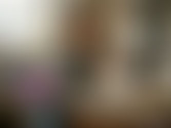 Woman tasting red wine in home kitchen